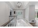 Bright entryway featuring marble floors, a decorative light fixture, and an elegant glass front door at 630 Buttercup Trce, Johns Creek, GA 30022