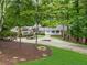 Charming brick home with lush landscaping, a circular driveway and a covered front porch at 630 Buttercup Trce, Johns Creek, GA 30022