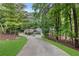 Secluded brick home with a long driveway and mature trees offers a private and peaceful setting at 630 Buttercup Trce, Johns Creek, GA 30022