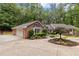 Charming brick home with a three car garage, circular driveway and mature landscaping at 630 Buttercup Trce, Johns Creek, GA 30022