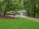 Charming brick home with lush landscaping, a circular driveway and a covered front porch at 630 Buttercup Trce, Johns Creek, GA 30022