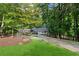 Charming brick home with lush landscaping, a circular driveway and a covered front porch at 630 Buttercup Trce, Johns Creek, GA 30022