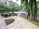 Charming brick home with lush landscaping, a circular driveway and a covered front porch at 630 Buttercup Trce, Johns Creek, GA 30022