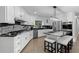Bright kitchen with white cabinets, granite countertops, stainless steel appliances, and an island with seating at 630 Buttercup Trce, Johns Creek, GA 30022