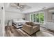 Bright main bedroom features a ceiling fan, stylish flooring, chair, and many windows to bring the outdoors in at 630 Buttercup Trce, Johns Creek, GA 30022