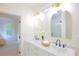 Bright bathroom featuring double sink vanity, marble countertop, gold fixtures, and an arched mirror over each sink at 1454 Rome Nw Dr, Atlanta, GA 30314