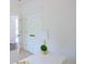 Clean bedroom includes bright white walls and trim, white paneled closet doors, and view into a connected room at 1454 Rome Nw Dr, Atlanta, GA 30314