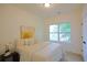 Cozy bedroom with a plush bed, soft lighting, and a window offering views of the outdoors at 1454 Rome Nw Dr, Atlanta, GA 30314