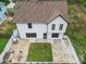 Aerial view of a two-story house with fenced yard featuring a stone patio and grass area at 2111 Nelms Pointe Lndg, Lawrenceville, GA 30043