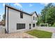 A white two-story house has a fenced yard with a stone patio and small grass area at 2111 Nelms Pointe Lndg, Lawrenceville, GA 30043