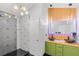 A modern bathroom with unique fixtures, dual sinks, and striking geometric shower tile at 2111 Nelms Pointe Lndg, Lawrenceville, GA 30043
