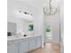 A full bathroom highlighting the chandelier lighting and double sink vanity at 2111 Nelms Pointe Lndg, Lawrenceville, GA 30043