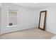 A cozy bedroom with natural light and a large mirror on the carpeted floor at 2111 Nelms Pointe Lndg, Lawrenceville, GA 30043