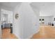 Hallway view showing modern kitchen with stainless appliances and an adjacent living area, highlighting an open floor plan at 2111 Nelms Pointe Lndg, Lawrenceville, GA 30043