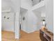 Spacious hallway with hardwood floors, white trim, and soaring ceiling showcasing the home's architectural details and open design at 2111 Nelms Pointe Lndg, Lawrenceville, GA 30043