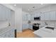This kitchen features sleek stainless appliances, lovely tile backsplash, and ample storage at 2111 Nelms Pointe Lndg, Lawrenceville, GA 30043