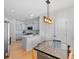 Bright eat-in kitchen boasts stainless appliances, custom cabinets, quartz counters, and a stylish light fixture at 2111 Nelms Pointe Lndg, Lawrenceville, GA 30043