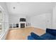 Bright and airy living room featuring a fireplace with built-in shelving, large windows, and hardwood flooring at 2111 Nelms Pointe Lndg, Lawrenceville, GA 30043