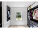 Walk-in closet with organizing system, shelving, hanging rods and a window at 2111 Nelms Pointe Lndg, Lawrenceville, GA 30043