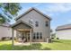 Backyard view of home featuring a covered patio with seating and a lush lawn at 2149 Apple Orchard Way, Austell, GA 30168
