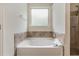 Relaxing bathroom with a soaking tub, a separate shower, and ceramic tile at 2149 Apple Orchard Way, Austell, GA 30168