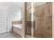 Bright bathroom featuring a glass shower enclosure, tub, and modern fixtures at 2149 Apple Orchard Way, Austell, GA 30168