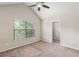 Bright bedroom featuring neutral walls, large window, ceiling fan, and closet at 2149 Apple Orchard Way, Austell, GA 30168