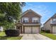 Charming brick two-story home featuring a two-car garage and manicured lawn at 2149 Apple Orchard Way, Austell, GA 30168