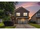 Exterior elevation of home with brick facade, two-car garage, and manicured lawn at 2149 Apple Orchard Way, Austell, GA 30168