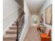 Inviting hallway features neutral tones, carpet, stairs, and decor, with an archway leading to the living space at 2149 Apple Orchard Way, Austell, GA 30168