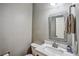 Nicely decorated half-bathroom features stylish vanity and decorative framed mirror at 2325 Walnut Grove Way, Suwanee, GA 30024