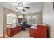 Office with wood desk and chair, lots of storage space, and views from the arched windows at 2325 Walnut Grove Way, Suwanee, GA 30024