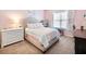 Bedroom featuring a decorative headboard, pastel bedding, white dresser, and a window at 2490 Tack Hill Ct, Dacula, GA 30019