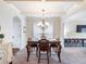 Elegant dining room featuring coffered ceilings, and a charming chandelier that provides ample lighting at 2490 Tack Hill Ct, Dacula, GA 30019