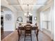 Elegant dining room featuring coffered ceilings, wainscoting and views to the kitchen for easy serving at 2490 Tack Hill Ct, Dacula, GA 30019