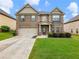 Charming two-story brick home with a well-manicured lawn and inviting curb appeal and an attached two car garage at 2490 Tack Hill Ct, Dacula, GA 30019