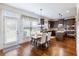 Eat-in kitchen with dark wood cabinets, stainless steel appliances, granite countertops, wood floors, and lots of natural light at 2490 Tack Hill Ct, Dacula, GA 30019