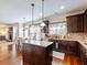 Well-equipped kitchen with granite countertops, hardwood floors, and views into the cozy living room at 2490 Tack Hill Ct, Dacula, GA 30019