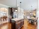 Modern kitchen with stainless steel appliances, granite countertops, and hardwood floors with views to the living area at 2490 Tack Hill Ct, Dacula, GA 30019