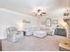 Comfortable living room with plush carpeting, neutral decor, a ceiling fan, and a stone fireplace at 2490 Tack Hill Ct, Dacula, GA 30019