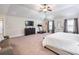 Spacious main bedroom with a ceiling fan, neutral decor, and plenty of space for workout equipment at 2490 Tack Hill Ct, Dacula, GA 30019