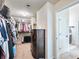 Well-organized walk-in closet with built-in shelving and plenty of storage space leading into bathroom at 2490 Tack Hill Ct, Dacula, GA 30019