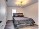 Cozy bedroom with a comfortable bed, wooden floors, and modern lighting, creating a serene and inviting atmosphere at 2876 Randall St, East Point, GA 30344