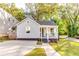 Charming light blue home with a cozy front porch and well-maintained landscaping at 2876 Randall St, East Point, GA 30344