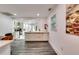 Open kitchen area with sleek white cabinetry, modern appliances, and hardwood flooring at 2876 Randall St, East Point, GA 30344