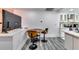Well-lit kitchen bar area with modern stools, stainless steel appliances, and sleek countertops at 2876 Randall St, East Point, GA 30344