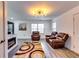 Inviting living room showcasing a decorative rug, leather seating, and contemporary lighting at 2876 Randall St, East Point, GA 30344