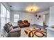 Comfortable living room featuring hardwood floors, a modern light fixture, and ample seating at 2876 Randall St, East Point, GA 30344