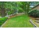 Grassy backyard with mature trees, stone landscaping and privacy fencing at 3902 Butterstream Way, Kennesaw, GA 30144