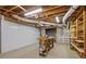 Unfinished basement area with exposed ducts, utility access, and storage shelving at 3902 Butterstream Way, Kennesaw, GA 30144